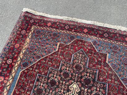 Hand-knotted wool rug featuring stylized...
