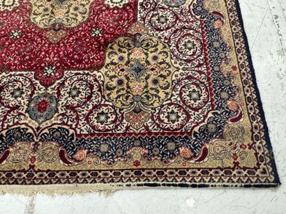 A significant hand-knotted wool rug featuring...