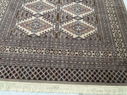 Large machine-woven wool rug featuring geometric...
