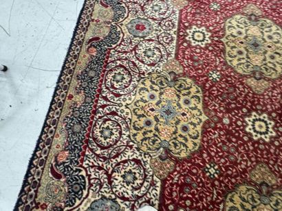 A significant hand-knotted wool rug featuring...