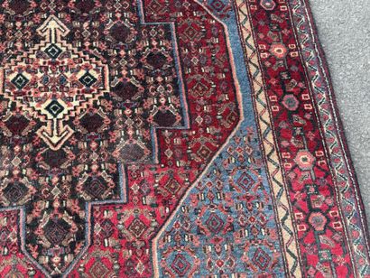 Hand-knotted wool rug featuring stylized...