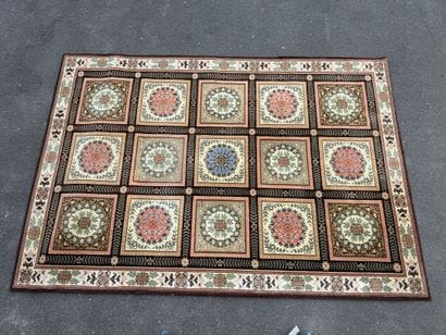 Large, multicolored machine-woven rug featuring...