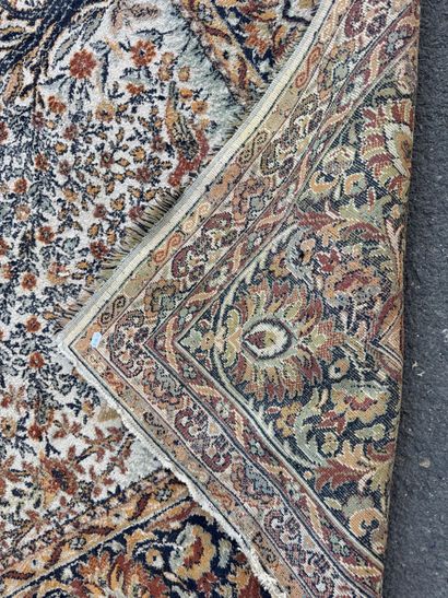 A significant hand-knotted wool rug featuring...