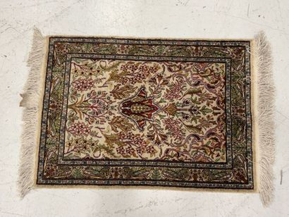 Small wool and silk rug with a leaf-and-vine...