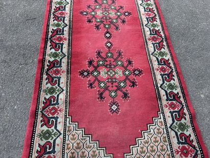 Hand-knotted wool gallery rug with a decorative...