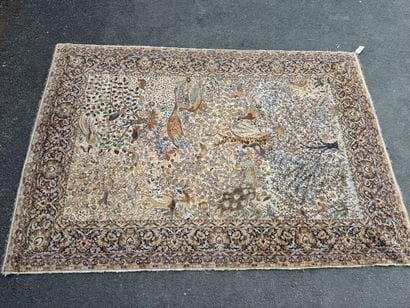 A significant hand-knotted wool rug featuring...