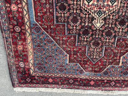 Hand-knotted wool rug featuring stylized...