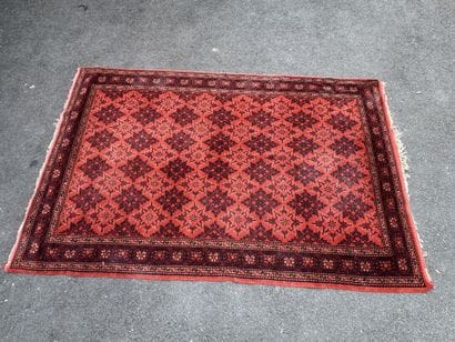 Hand-knotted wool rug with an orange background.
215...