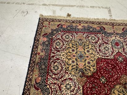 A significant hand-knotted wool rug featuring...