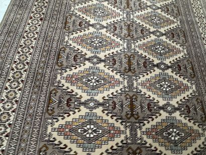 Large machine-woven wool rug featuring geometric...