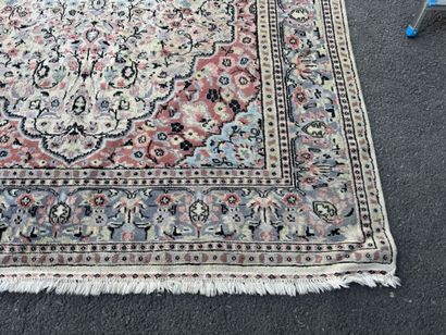 A large, hand-knotted wool rug featuring...