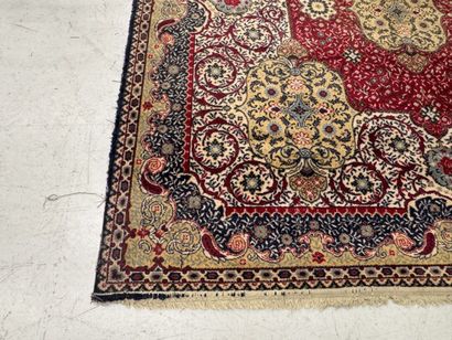 A significant hand-knotted wool rug featuring...