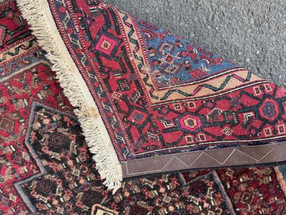 Hand-knotted wool rug featuring stylized...