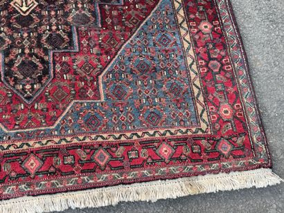 Hand-knotted wool rug featuring stylized...