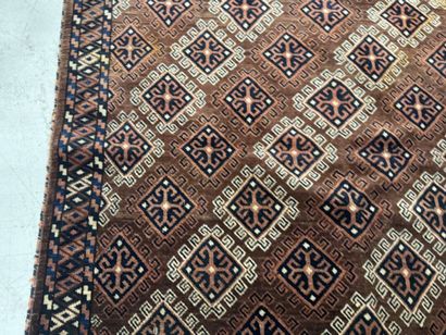 Hand-knotted wool rug featuring stylized...