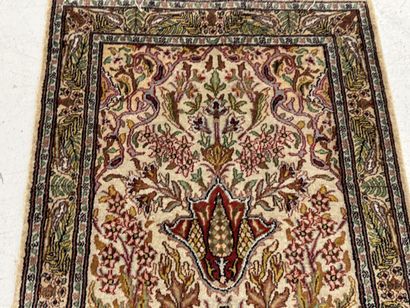 Small wool and silk rug with a leaf-and-vine...