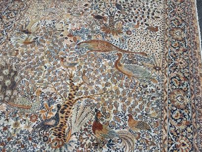 A significant hand-knotted wool rug featuring...