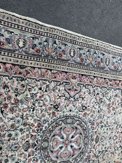 A large, hand-knotted wool rug featuring...