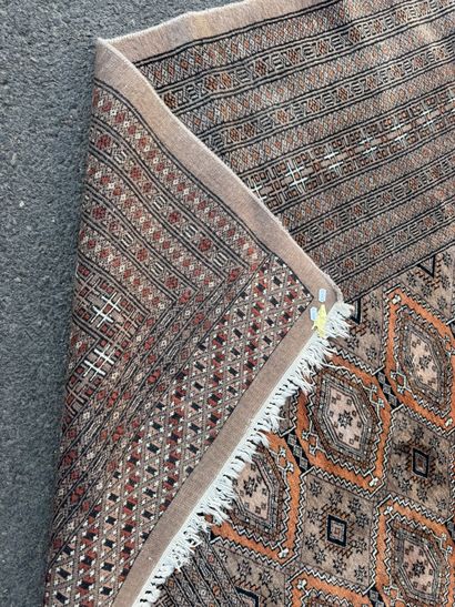 Large hand-knotted wool rug featuring stylized...