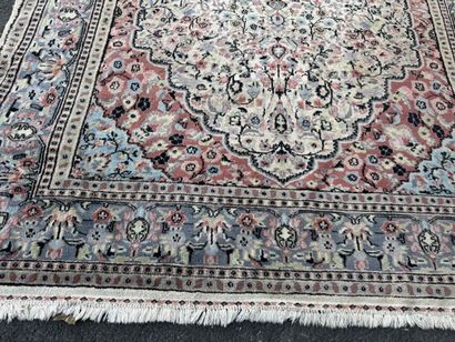 A large, hand-knotted wool rug featuring...