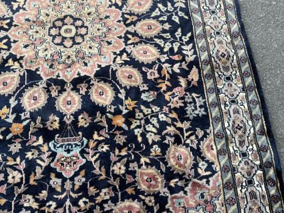 Hand-knotted wool rug featuring a foliage...