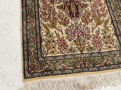 Small wool and silk rug with a leaf-and-vine...