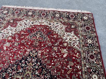 Machine-woven wool rug with a knotted design...