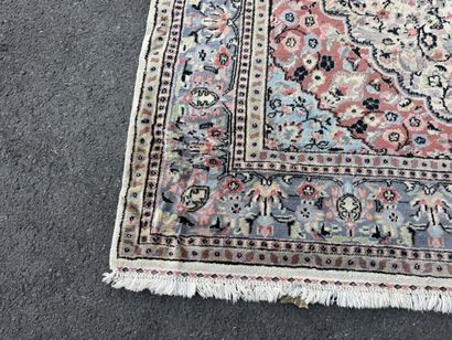 A large, hand-knotted wool rug featuring...