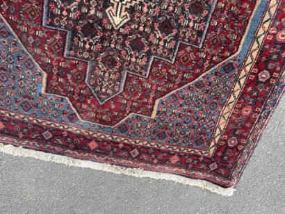 Hand-knotted wool rug featuring stylized...