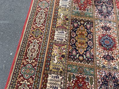 Large, multicolored machine-woven rug featuring...