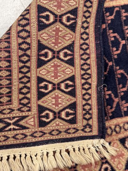 Small hand-knotted wool rug with stylized...