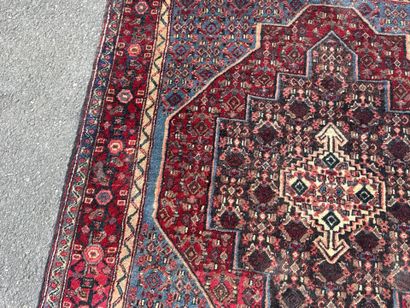 Hand-knotted wool rug featuring stylized...