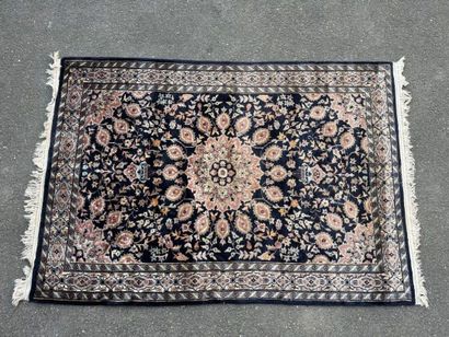 Hand-knotted wool rug featuring a foliage...