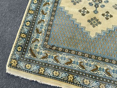 Hand-knotted wool rug featuring stylized...