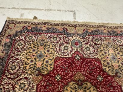 A significant hand-knotted wool rug featuring...