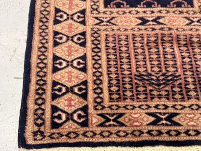 Small hand-knotted wool rug with stylized...