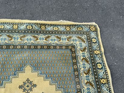 Hand-knotted wool rug featuring stylized...