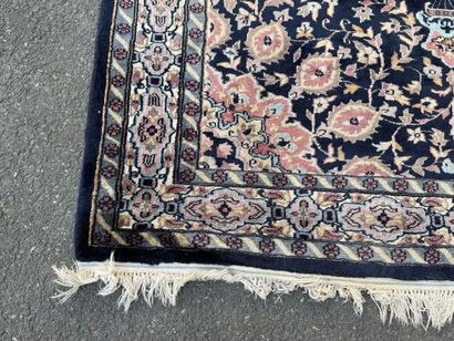 Hand-knotted wool rug featuring a foliage...