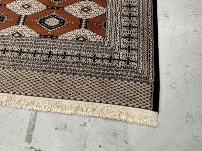 Large machine-woven wool rug featuring geometric...