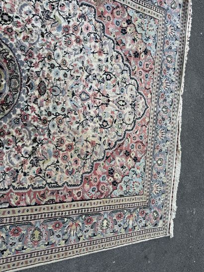 A large, hand-knotted wool rug featuring...