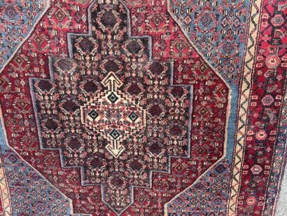Hand-knotted wool rug featuring stylized...