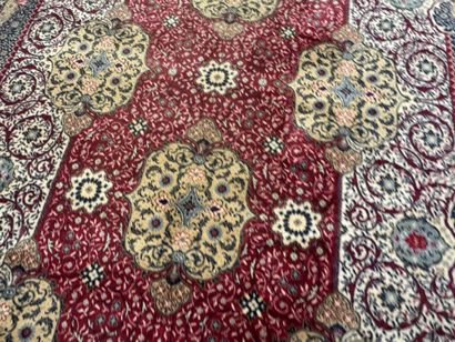 A significant hand-knotted wool rug featuring...