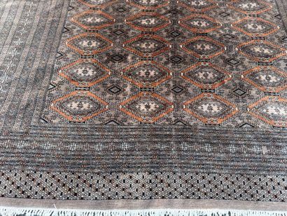 Large hand-knotted wool rug featuring stylized...