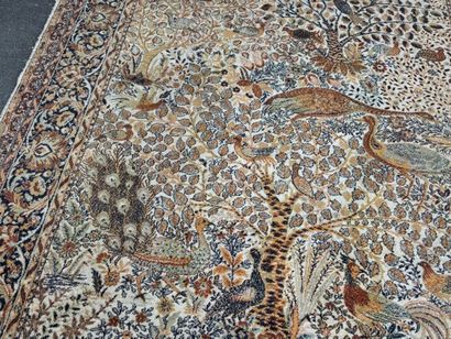 A significant hand-knotted wool rug featuring...