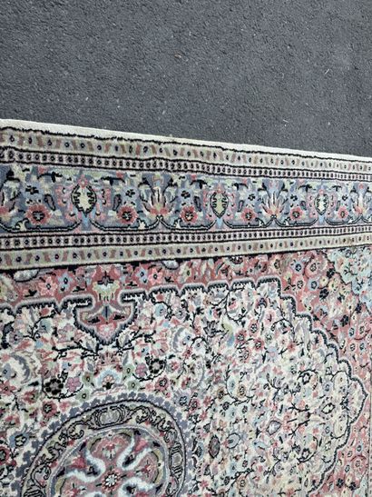 A large, hand-knotted wool rug featuring...
