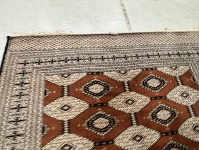 Large machine-woven wool rug featuring geometric...