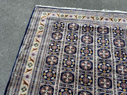 Hand-knotted wool rug with a blue background.
122...