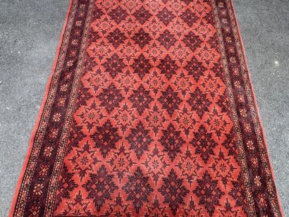 Hand-knotted wool rug with an orange background.
215...