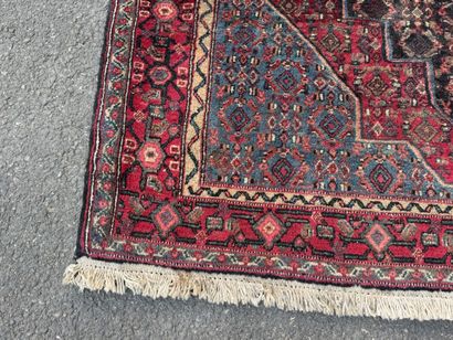 Hand-knotted wool rug featuring stylized...