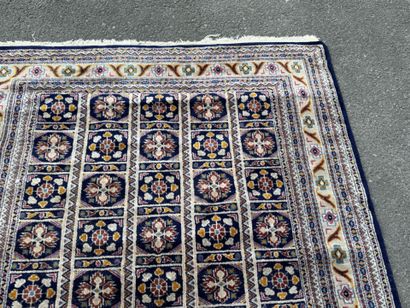 Hand-knotted wool rug with a blue background.
122...